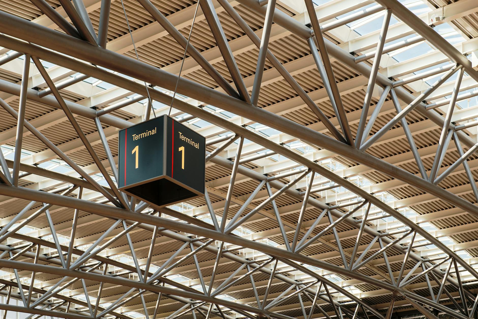 Sydney transport guide - interior of a modern airport terminal with travellers and departure boards