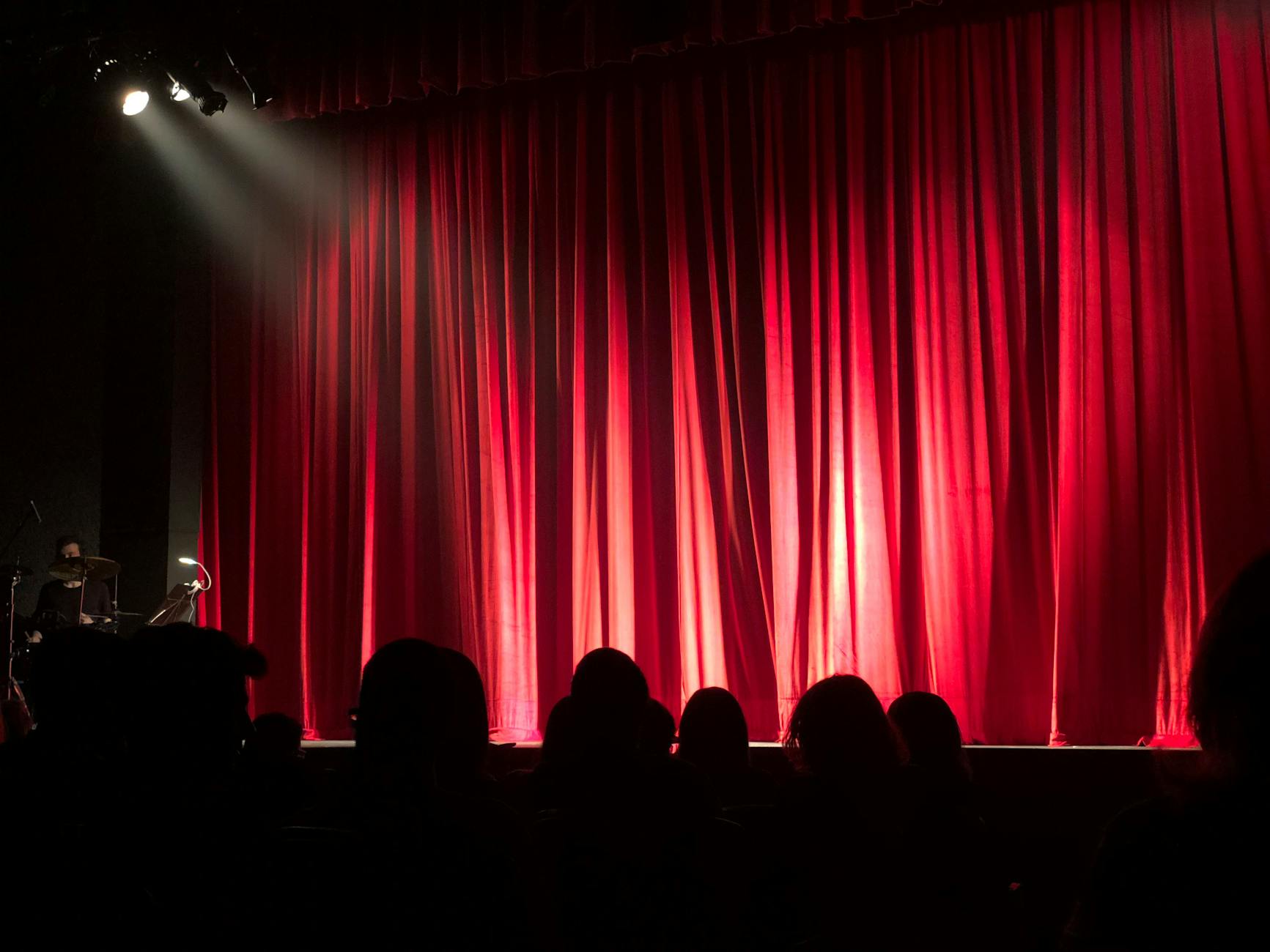 Comedy show with audience laughing and performer on stage