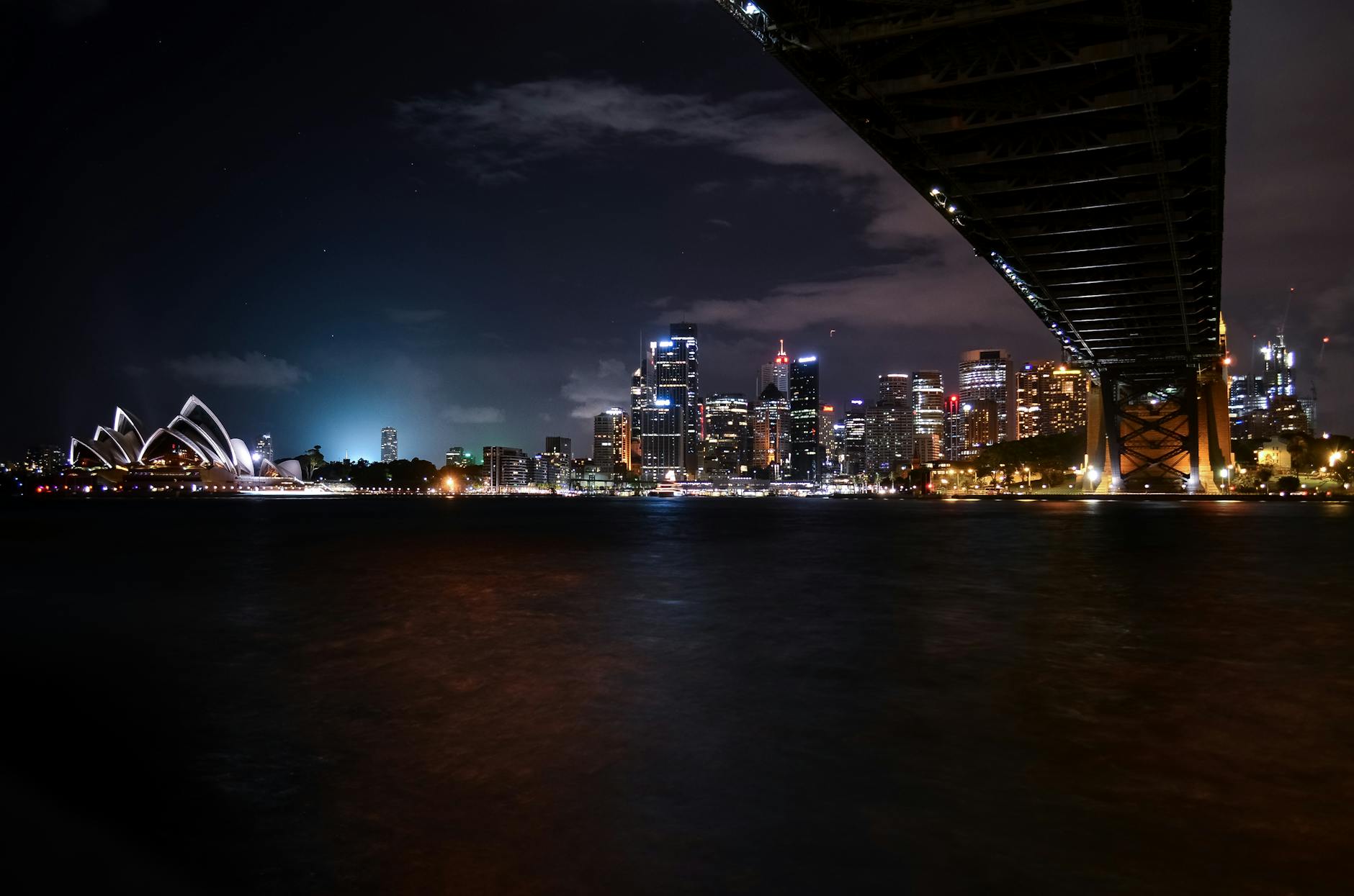 Sydney Harbour lit up at night from a cruise