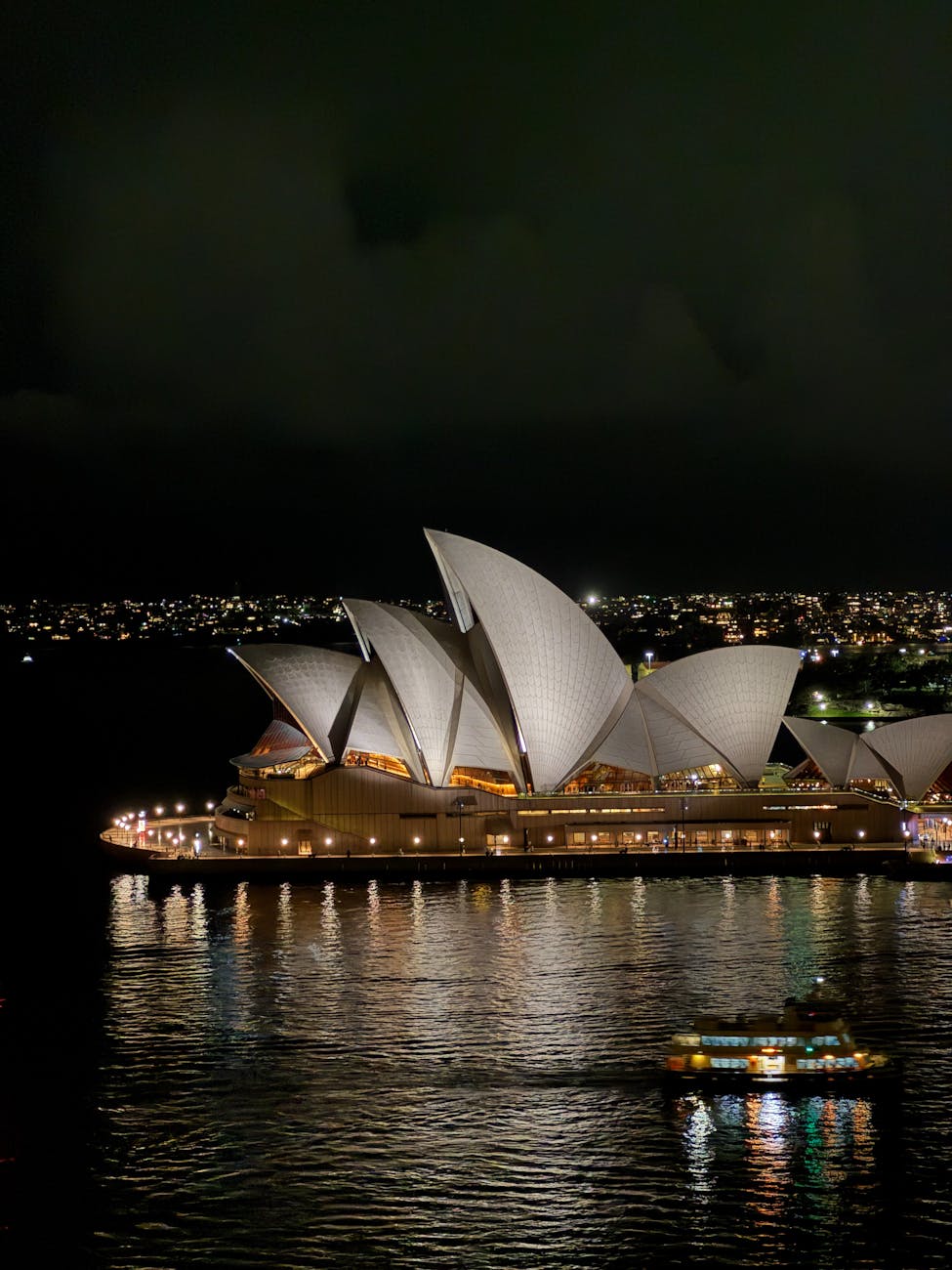 Sydney Opera House lit up at night for a performance event
