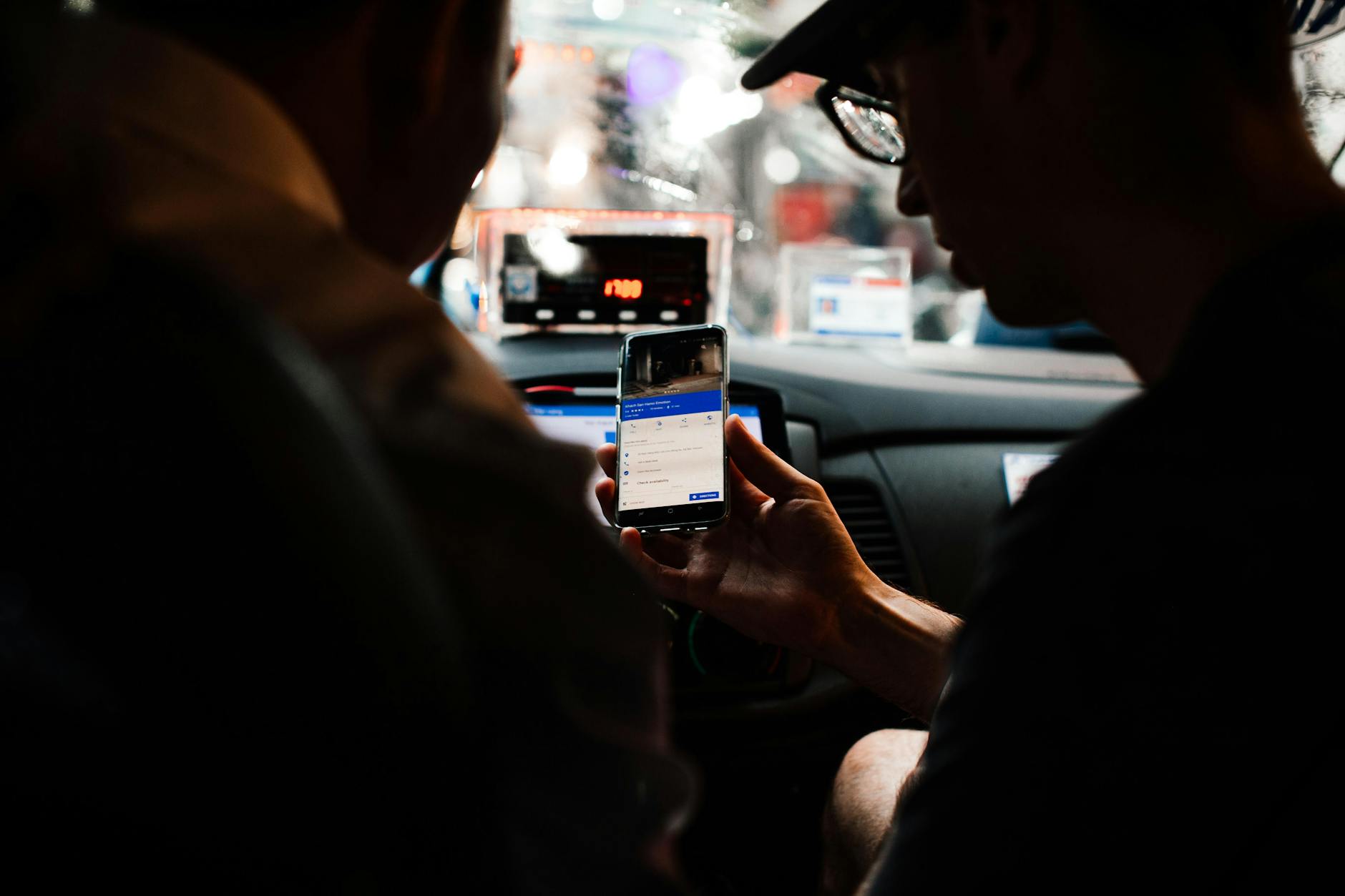 Sydney transport guide - taxi cab driving through city streets at night with urban lights
