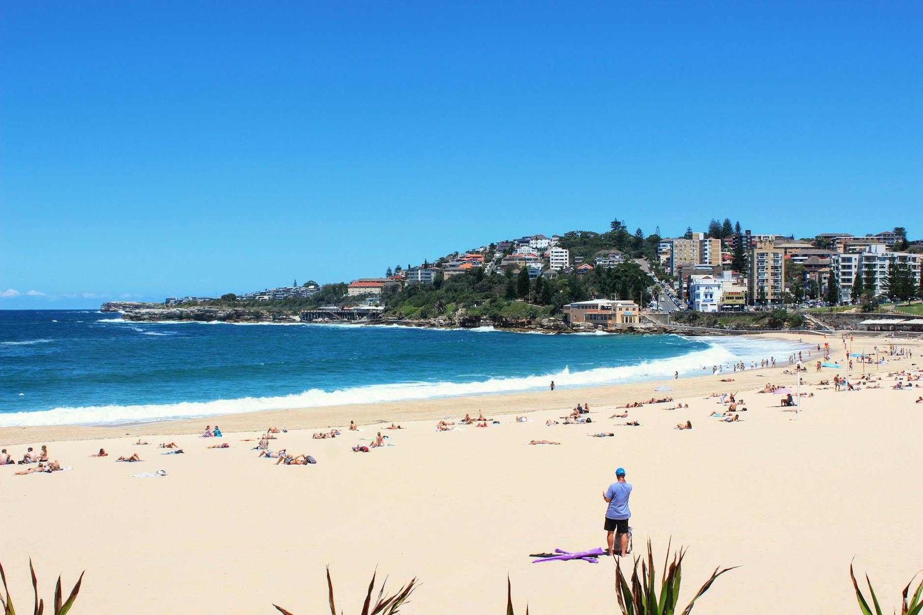 Sydney with kids - children playing on Bondi Beach with surfboards