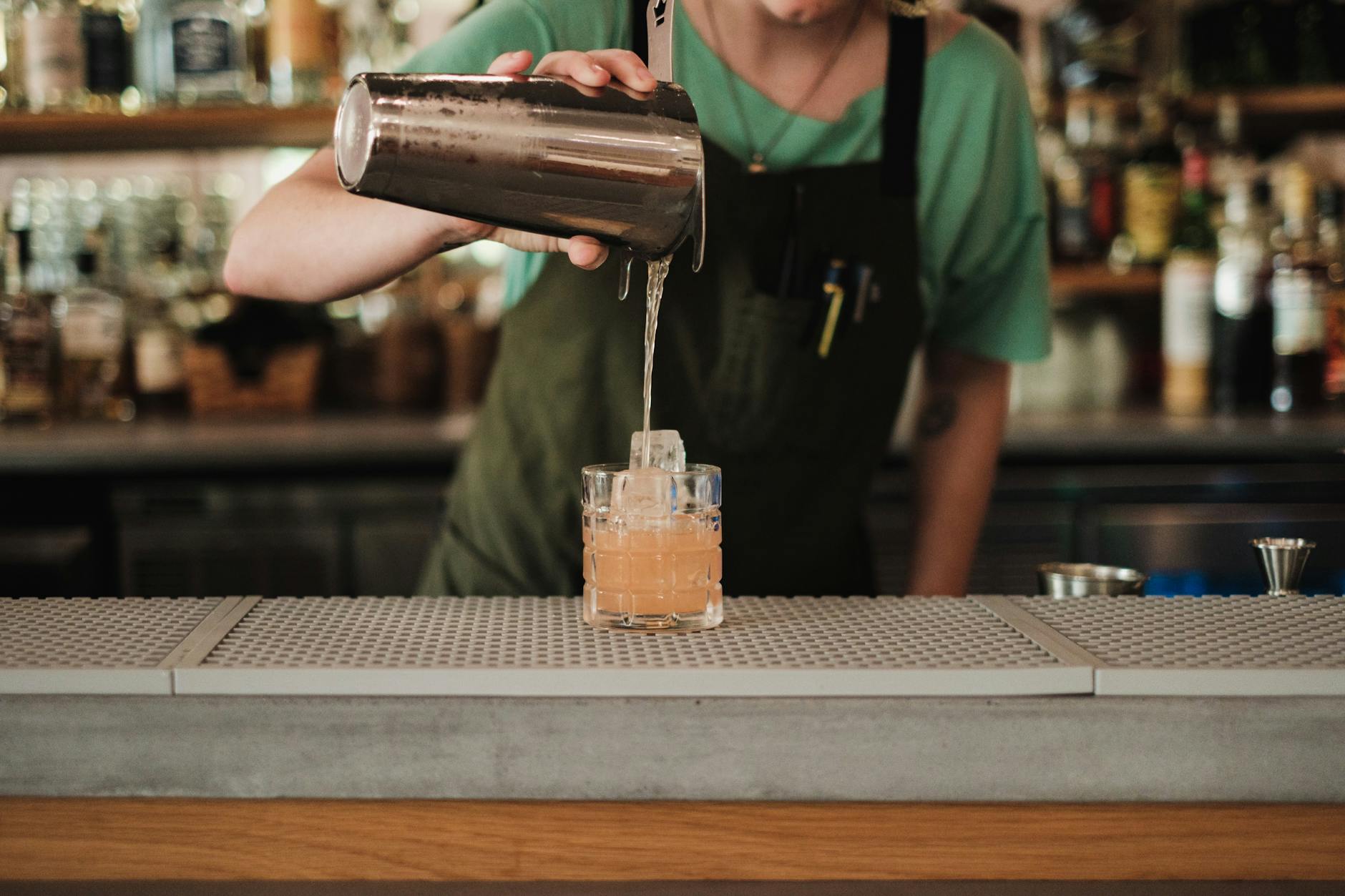 Rooftop bars Sydney - bartender pouring cocktail city view