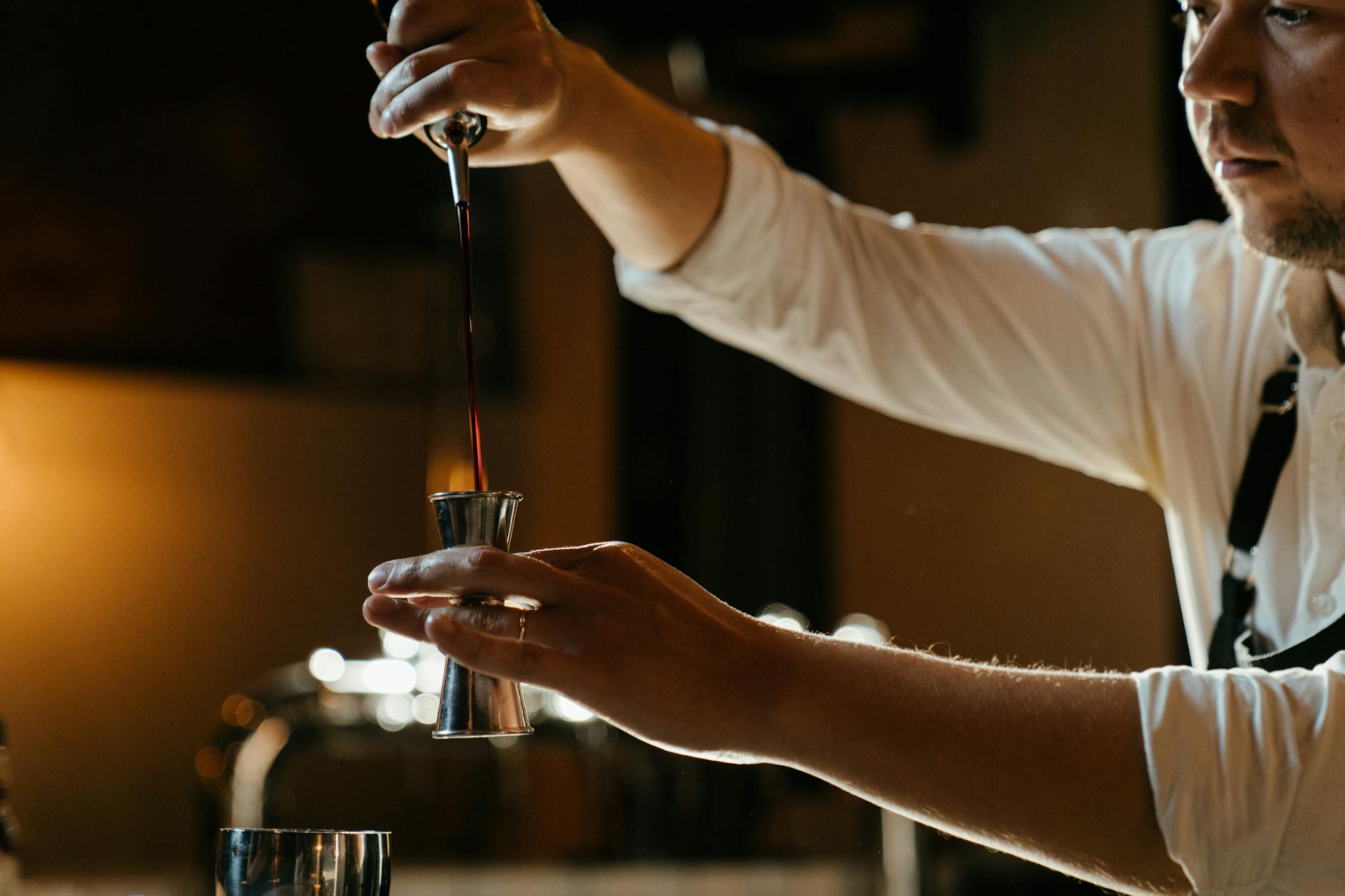 Sydney nightlife - cocktail bar with bartender pouring drinks