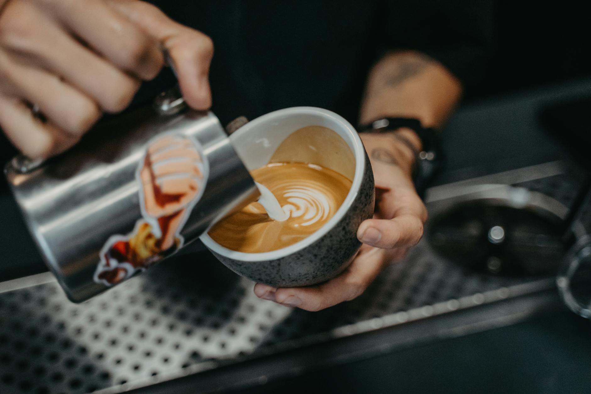 Sydney coffee - barista pouring latte art in specialty cafe