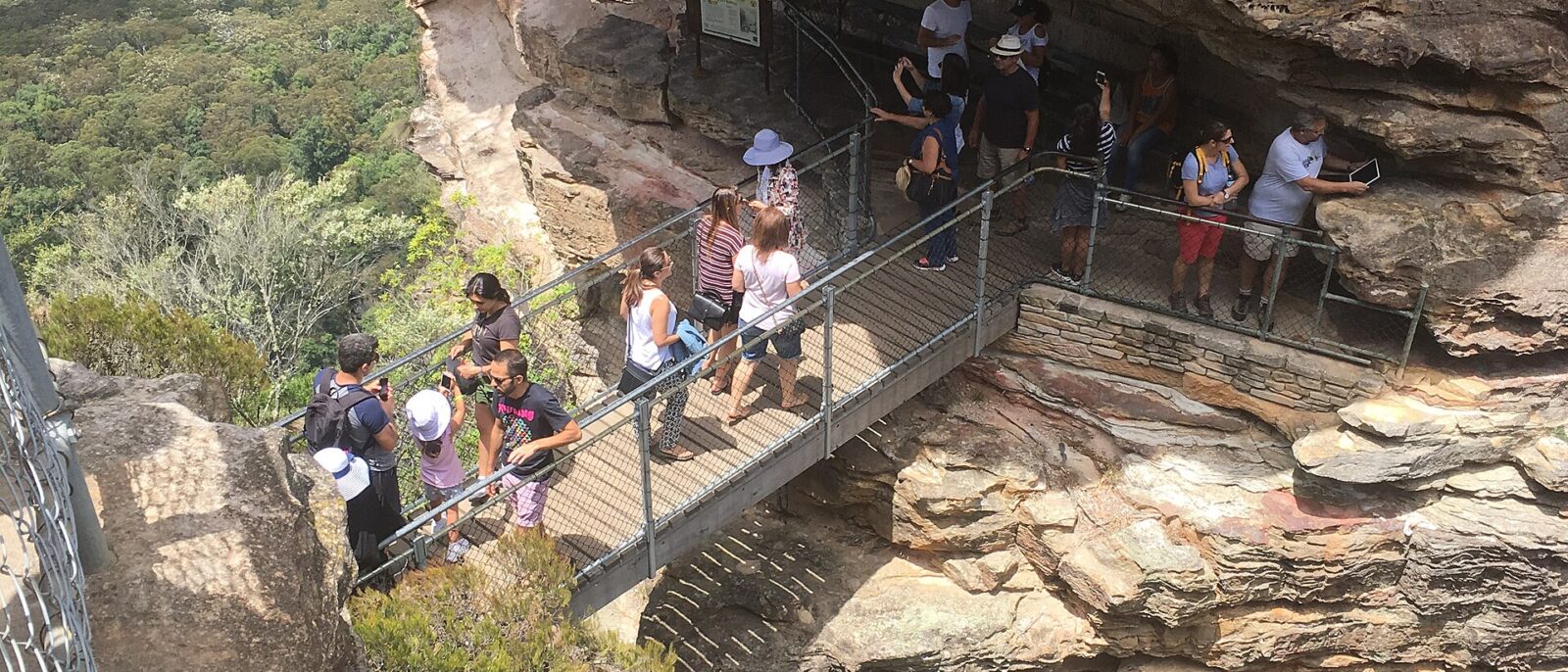 Visitors on the steel walkway and bridge at the first of the Three Sisters above the Giant Stairway