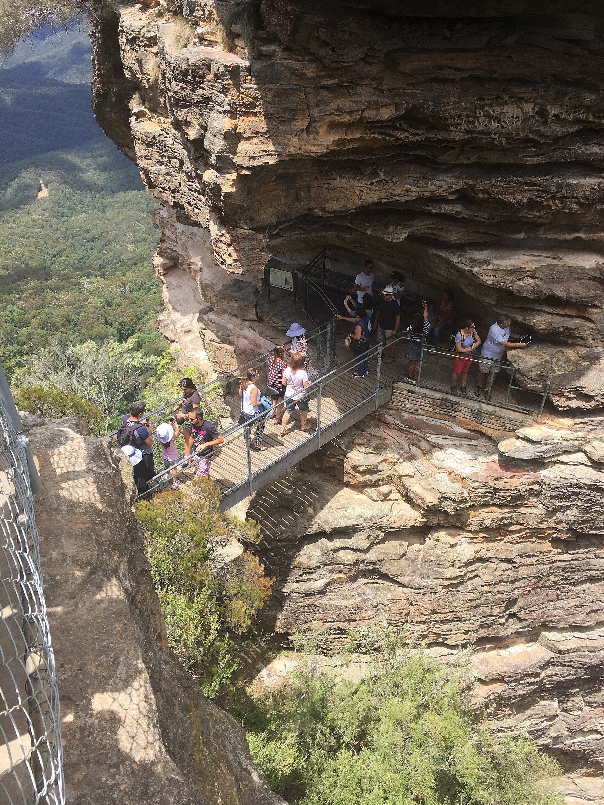 Visitors on the steel walkway and bridge at the first of the Three Sisters above the Giant Stairway